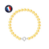 Le bracelet NOELYSE de Perlinea, en or blanc et perles dorées, est présenté sur un fond blanc. Dans le coin supérieur gauche, un badge indique "Artisan Bijoutier Français", mettant en valeur l'élégance de la joaillerie française.